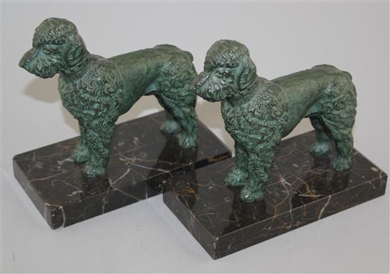 A pair of French Art Deco patinated metal bookends, modelled as poodles, 6in.